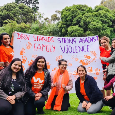 DBSV team members standing with a 16 Days banner